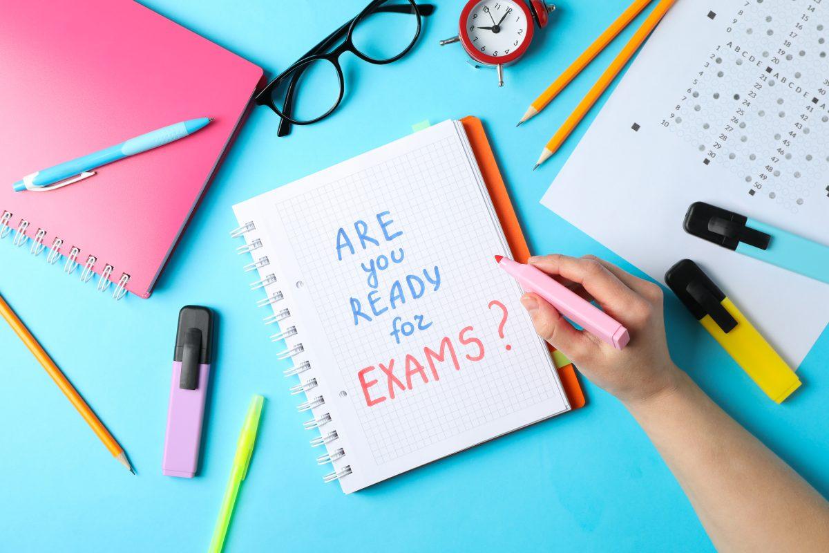 Inscription Are you ready for exams? Woman hold marker on blue background. Study and exam concept