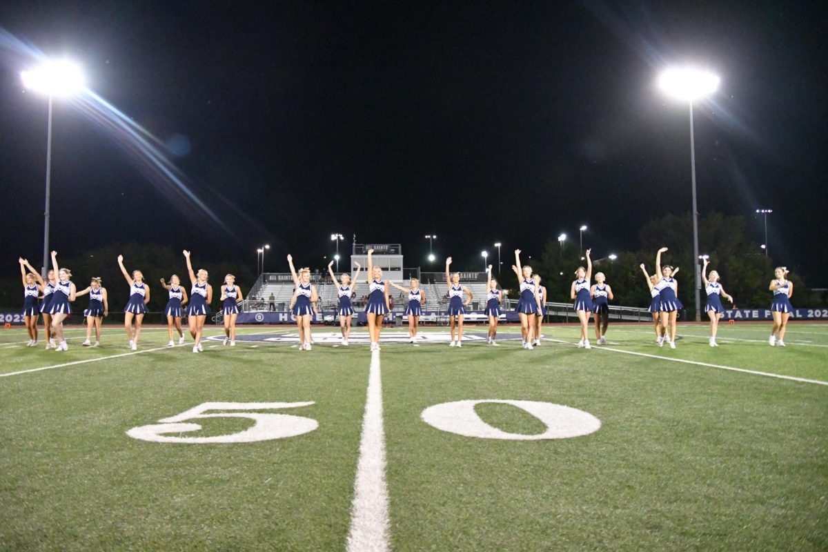 Cheering at Varsity football game against Lift For Life Academy 