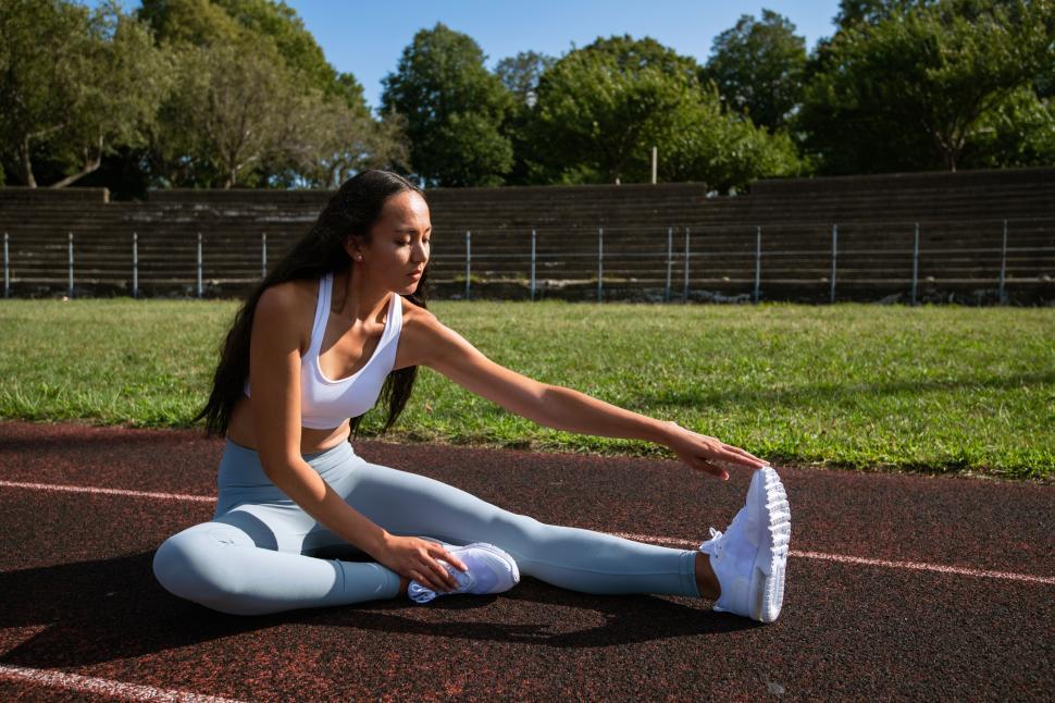 Athlete stretching on track